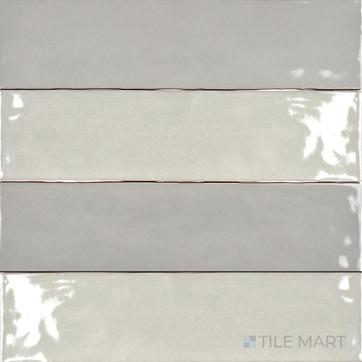 The Bar Tile Oslo 3x12 inch bright ceramic tile displays a sleek, glossy surface in a neutral tone, viewed from above to highlight its smooth finish and elongated shape.