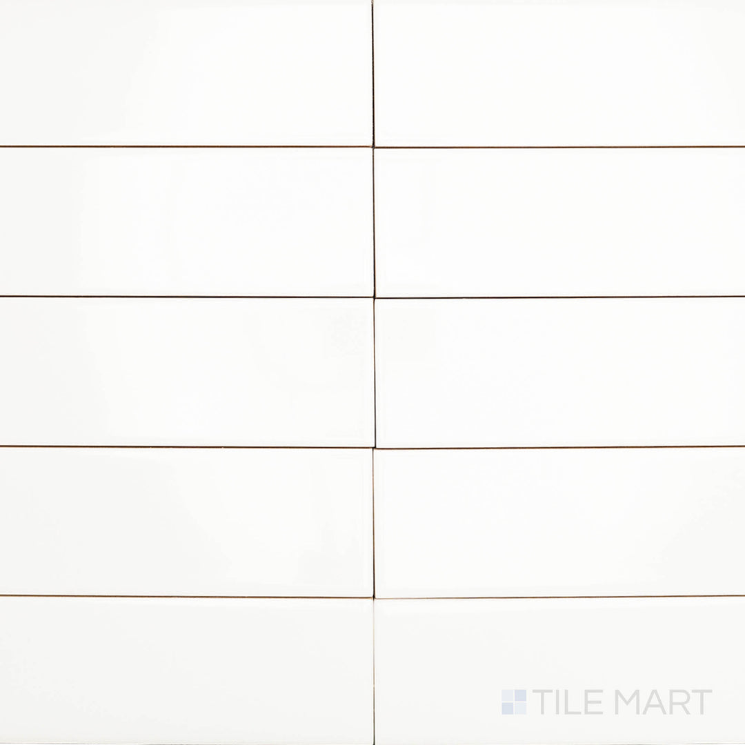 This overhead shot of the Block Blanco 2x10 inch bright ceramic tile captures its crisp white tone and reflective surface, enhancing light and creating a clean, modern aesthetic.