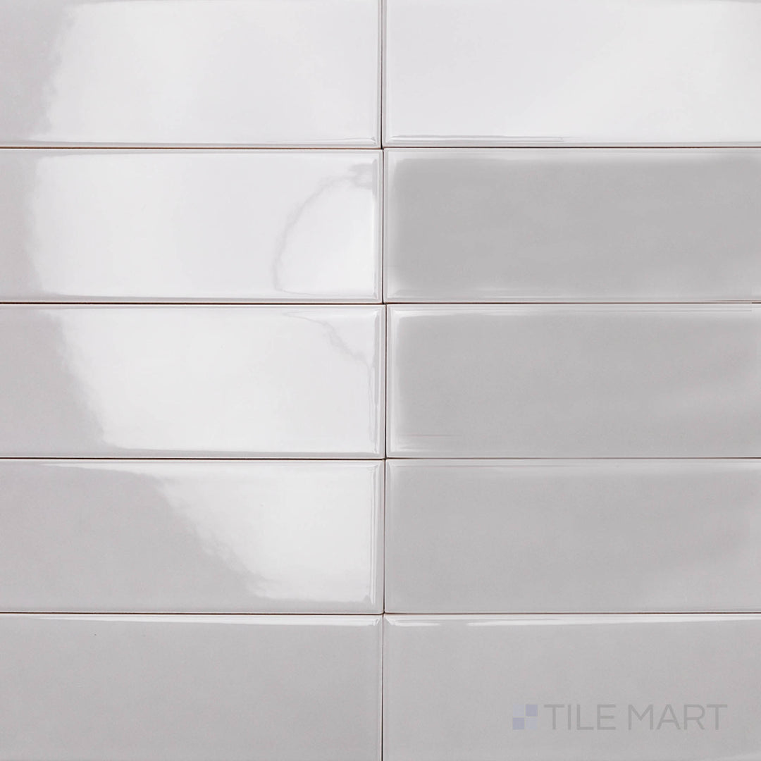 A sleek, steel-gray ceramic tile with a glossy finish, viewed from above to highlight its smooth texture and elongated 2x10 inch shape, ideal for contemporary spaces.