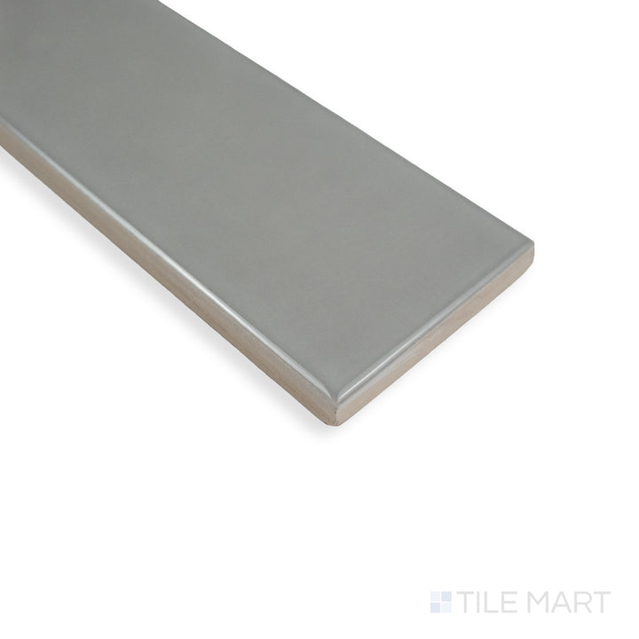 Corner-focused image of Block Acero 2X10 bright ceramic tile, highlighting its steel-gray tone, high-gloss glaze, and the precise tile junction.