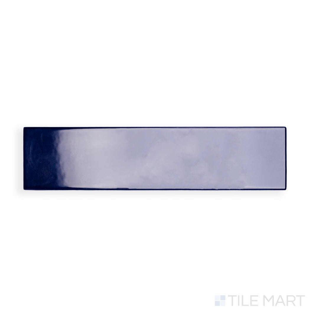 A high-resolution close-up of Block Azul 2X10 Bright Ceramic captures its vibrant blue color and reflective surface, bringing a bold accent to walls and backsplashes.