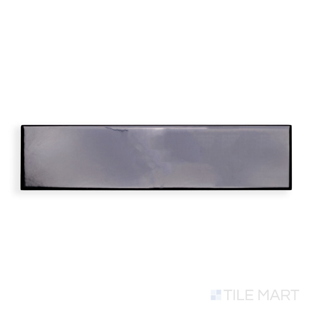 A detailed close-up of Block Negro 2X10 Bright Ceramic showcases its deep black hue with a sleek gloss, delivering an elegant and dramatic effect.