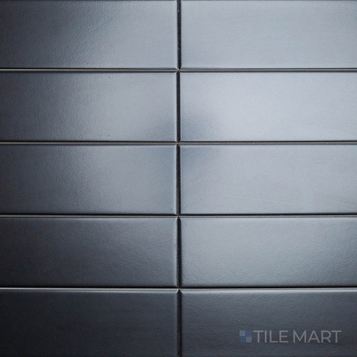 An overhead view of the Block Negro 2x10 inch matte ceramic tile captures its deep black tone and velvety texture, offering a bold yet understated design element.