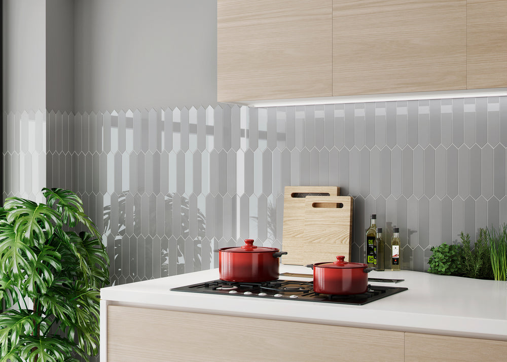 A dynamic and modern backsplash featuring Block Gris 2x10 Arrow bright ceramic tiles. The unique arrow pattern and light grey tone bring movement and depth to any contemporary space.