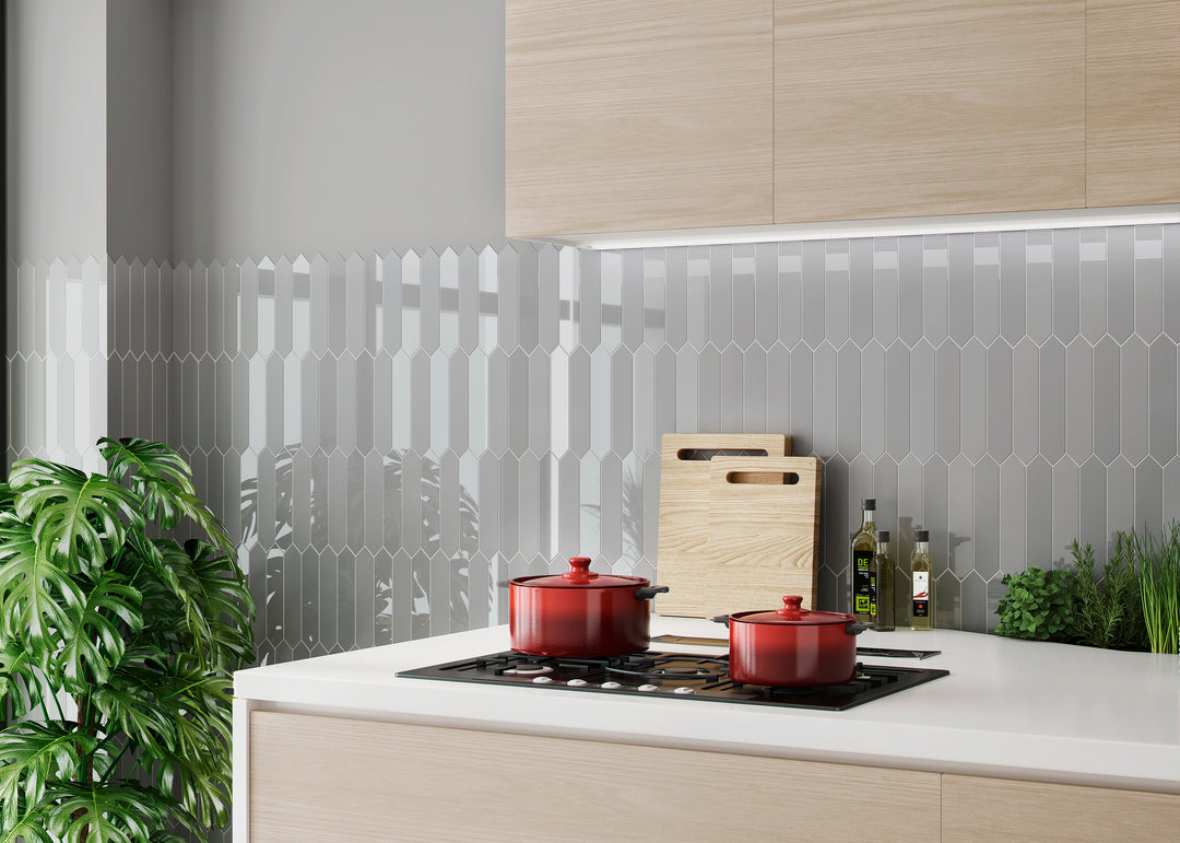 A dynamic and modern backsplash featuring Block Gris 2x10 Arrow bright ceramic tiles. The unique arrow pattern and light grey tone bring movement and depth to any contemporary space.