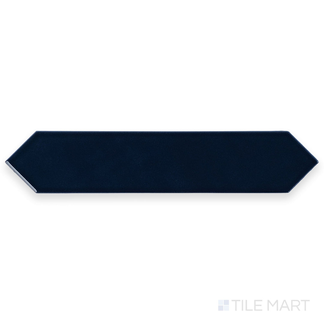 Photographed from above, the Block Azul 2x10 Arrow Bright ceramic tile reveals a bold blue tone with a high-gloss surface and directional texture.