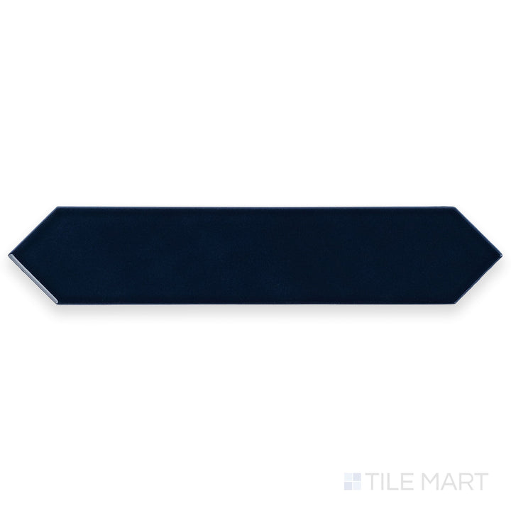 Photographed from above, the Block Azul 2x10 Arrow Bright ceramic tile reveals a bold blue tone with a high-gloss surface and directional texture.