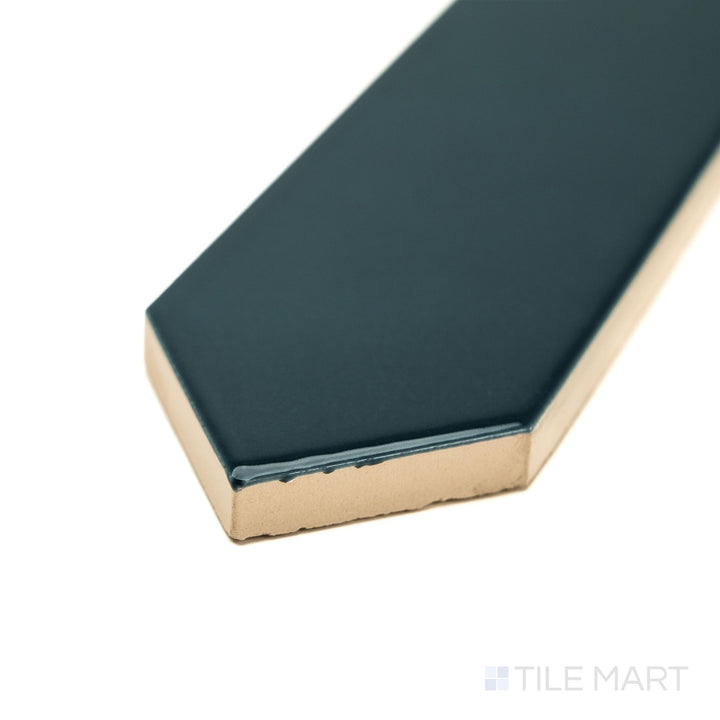 Angled corner shot of Block Verde 2x10 Arrow Bright ceramic tile in rich green, capturing its high-shine glaze and directional surface design for eye-catching interior features.