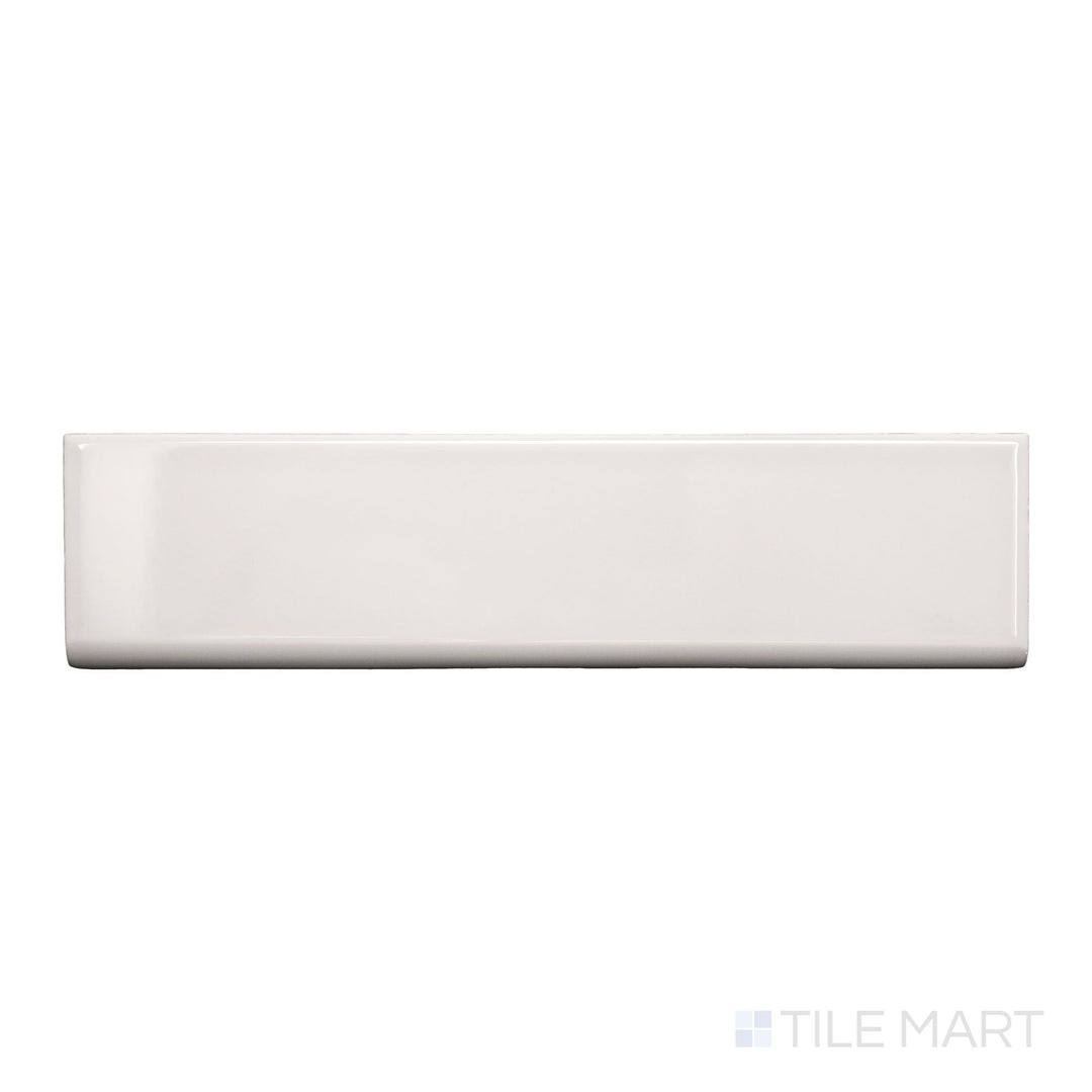 A top-down view of Block Gris 2x10 bright ceramic bullnose, showcasing its sleek grey tone and glossy finish.