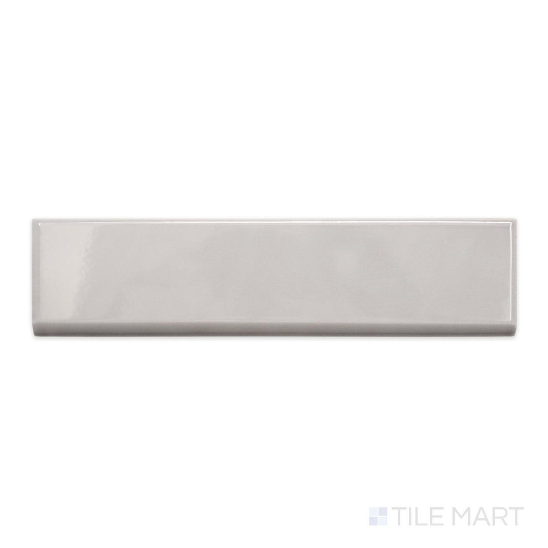 An overview of Block Acero 2x10 bright ceramic bullnose, featuring its soft steel-grey hue and high-gloss shine.