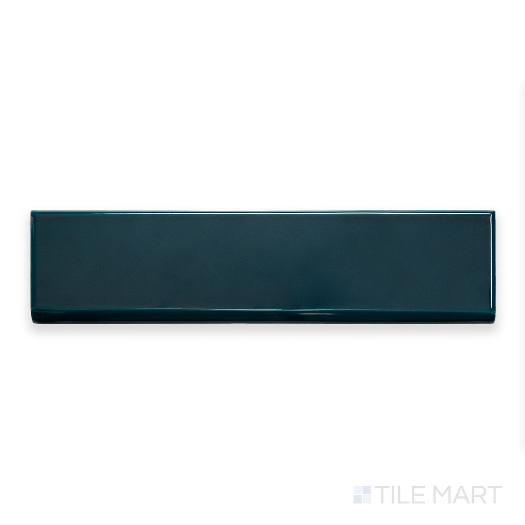 A flat-lay shot of Block Verde 2x10 bright ceramic bullnose, displaying its rich green tone and glossy ceramic finish.