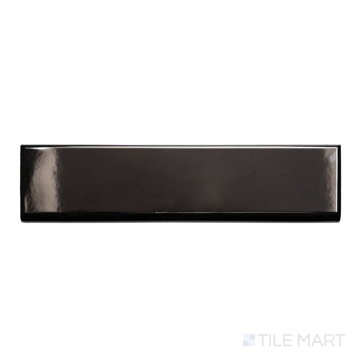 A top-down view of Block Negro 2x10 bright ceramic bullnose, showcasing its deep black color and glossy, reflective surface.