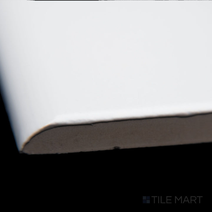 A detailed corner view of Block Blanco 2x10 matte ceramic bullnose, showcasing its clean white tone, softened edges, and subtle matte surface.