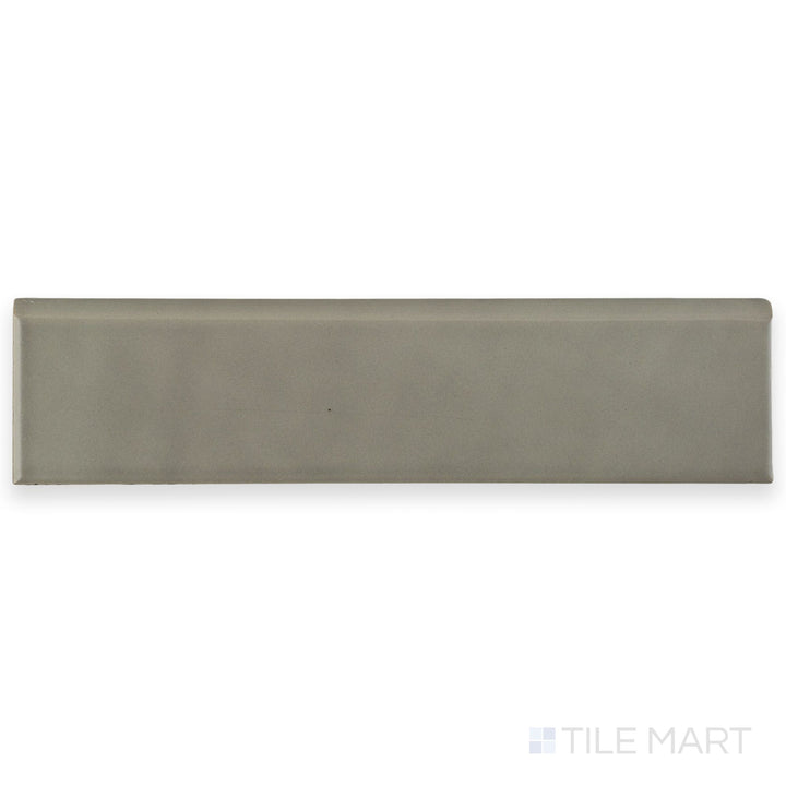 Flat lay of Block Acero 2x10 Matte Ceramic Bullnose tile in steel gray, featuring its rounded bullnose edge and understated matte texture.