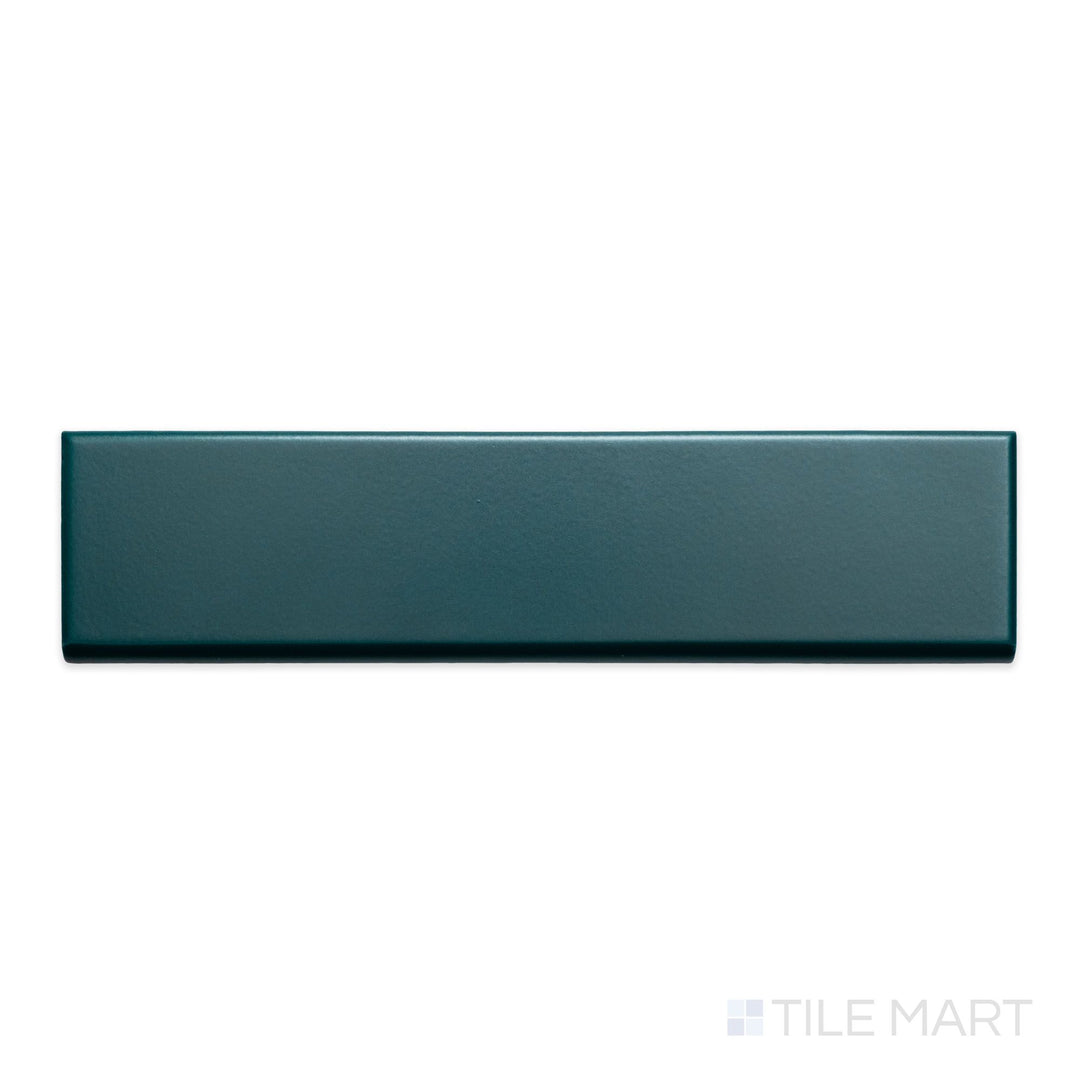 A detailed top-down view of Block Verde 2x10 matte ceramic bullnose, emphasizing its rich green hue and subtle matte surface.