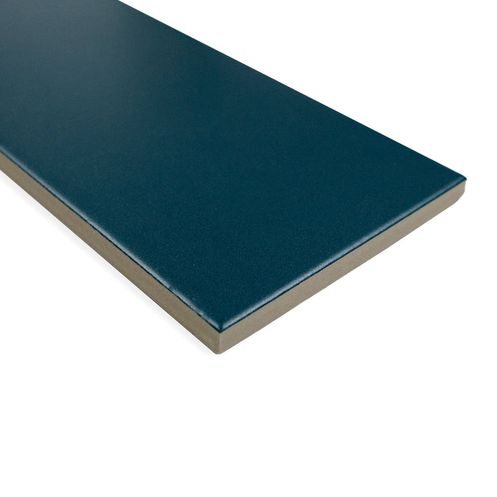 Corner-focused image of Block Verde 4X24 matte glazed porcelain tile, displaying its vibrant green tone, soft texture, and precise edge transition.