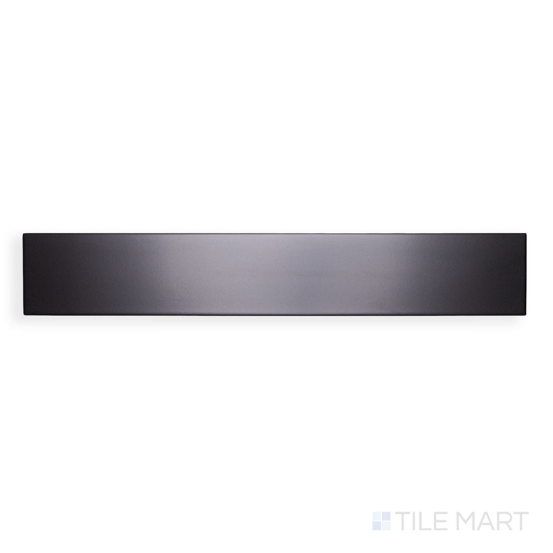 A high-resolution close-up of Block Negro 4X24 Matte Glazed Porcelain emphasizes its bold black hue and sleek matte texture, offering a timeless and dramatic effect.