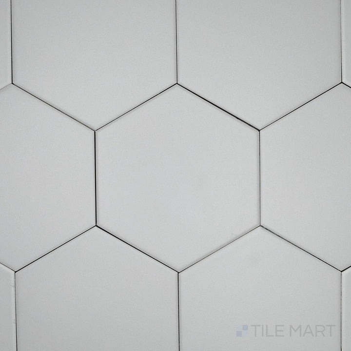 An overhead perspective of the Block Gris 6-inch hexagon matte glazed porcelain tile reveals its soft gray color and non-glossy surface, offering a versatile and contemporary feel.
