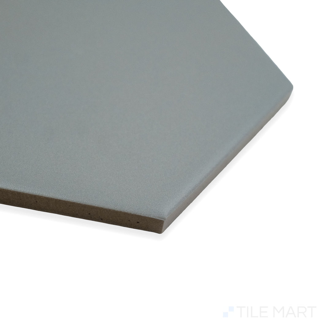 Close-up corner shot of Block Acero 6" hexagon matte glazed porcelain tile, highlighting its industrial gray color, velvety matte surface, and precisely aligned hexagonal edges.
