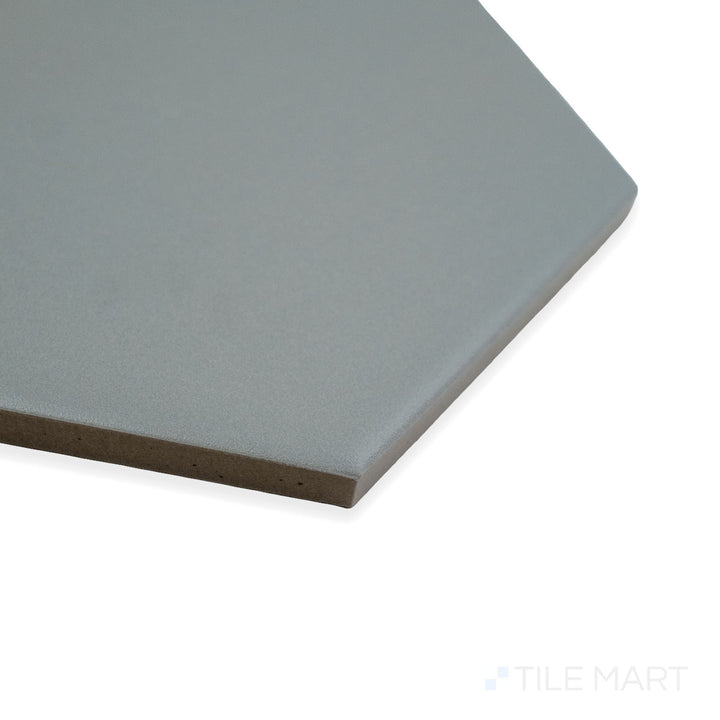 Close-up corner shot of Block Acero 6" hexagon matte glazed porcelain tile, highlighting its industrial gray color, velvety matte surface, and precisely aligned hexagonal edges.