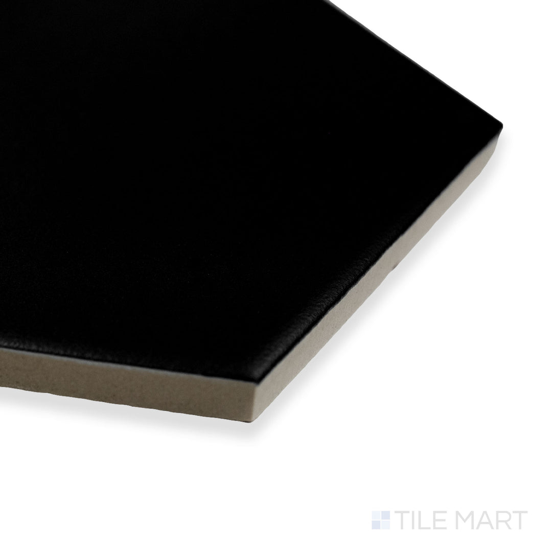 Side-angle close-up of Block Negro 6" hexagon matte glazed porcelain tile, emphasizing its rich black color, soft matte surface, and precise hexagonal corner transition.
