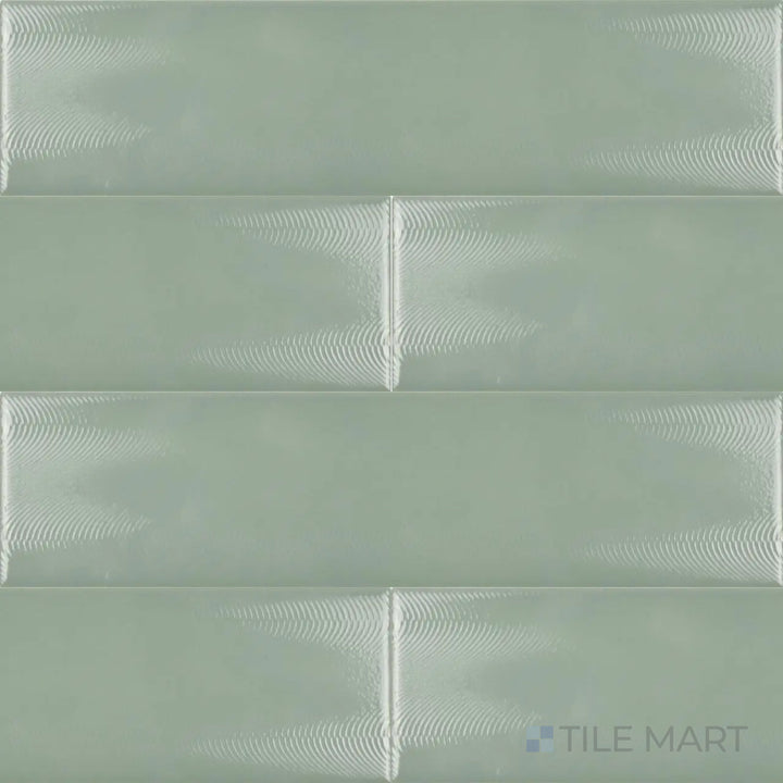 An overhead view of the Cc Cosmos Sage Green 3x12 inch bright ceramic tile highlights its soft green hue and glossy finish, bringing a refreshing and contemporary touch to any space.