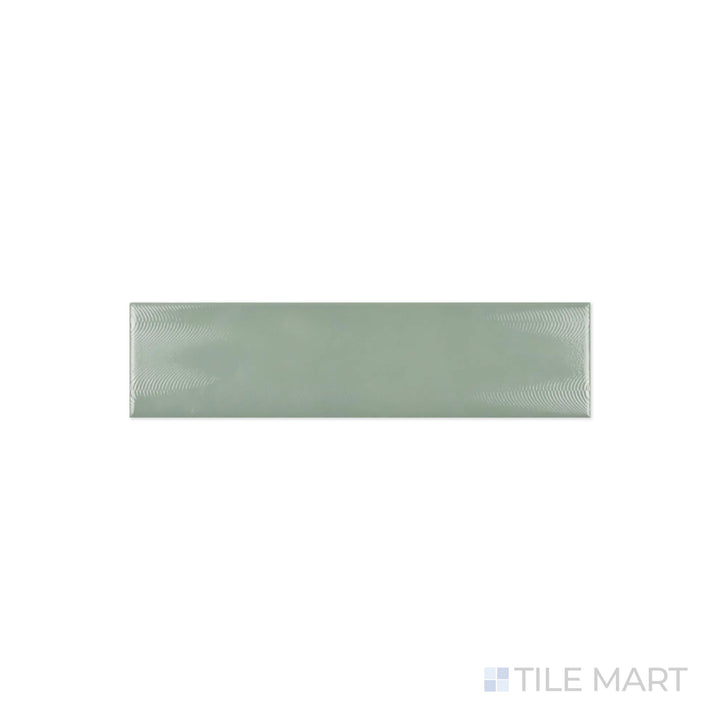 A close-up of Cc Cosmos Sage Green 3X12 Bright Ceramic showcases its soft green hue with a glossy finish, adding a natural and serene touch to interiors.