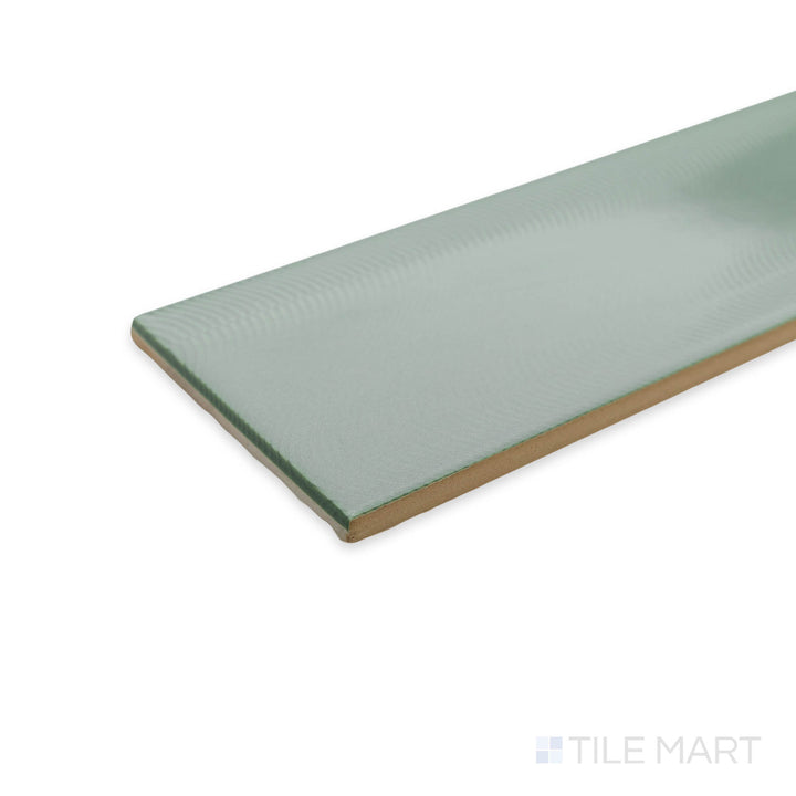 Corner shot of Cc Cosmos Sage Green 3X12 bright ceramic tile, displaying its earthy green hue, glossy surface, and the precise tile intersection.