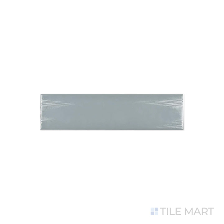 A macro shot of Cc Cosmos Mist 3X12 Bright Ceramic highlights its cool misty gray shade and high-gloss surface, ideal for modern and minimalist spaces.