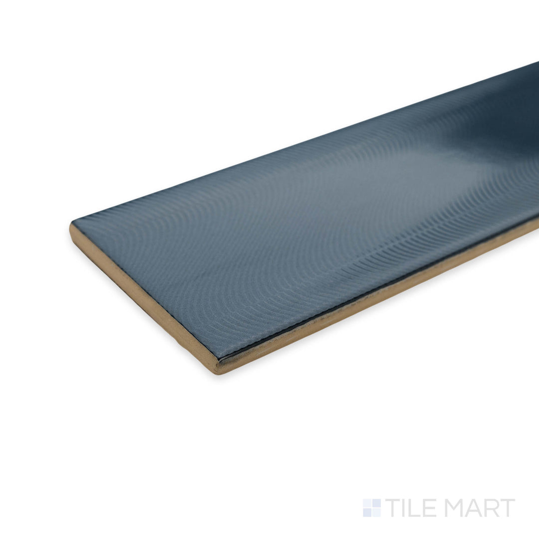 Side view of Cc Cosmos Petrol 3X12 bright ceramic tile, showcasing its deep petrol blue shade, smooth glazed finish, and structured edge transition at the corner.
