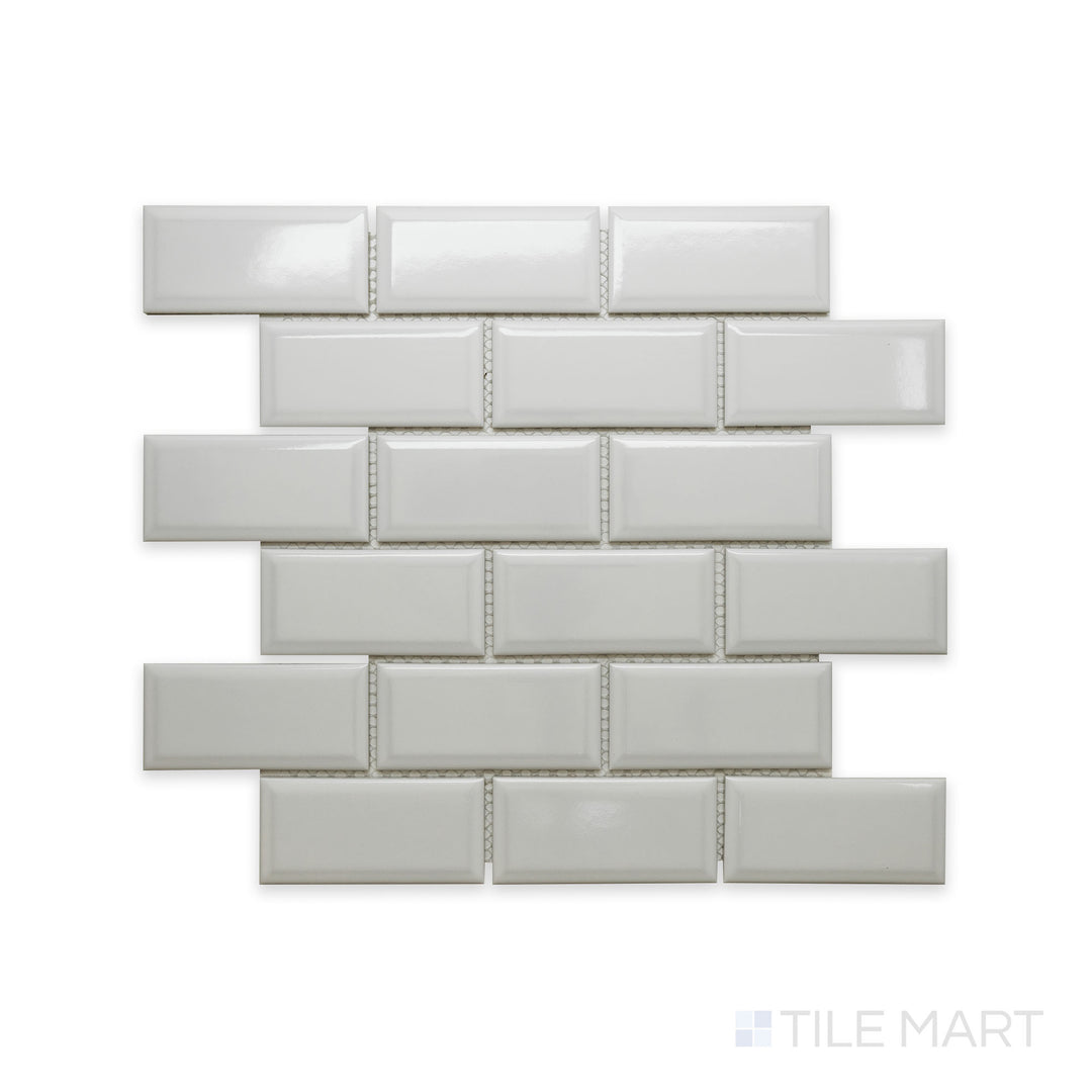 A close-up view of Cc Mosaics Plus White Ice 2X4 Beveled Bright Glazed Porcelain showcases its beveled edges and glossy surface, adding depth and dimension to walls.