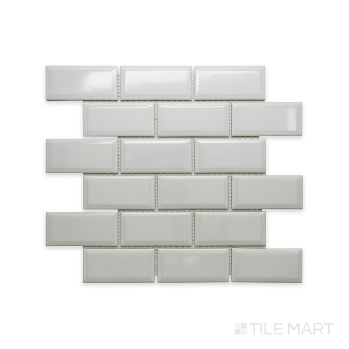 A close-up view of Cc Mosaics Plus White Ice 2X4 Beveled Bright Glazed Porcelain showcases its beveled edges and glossy surface, adding depth and dimension to walls.