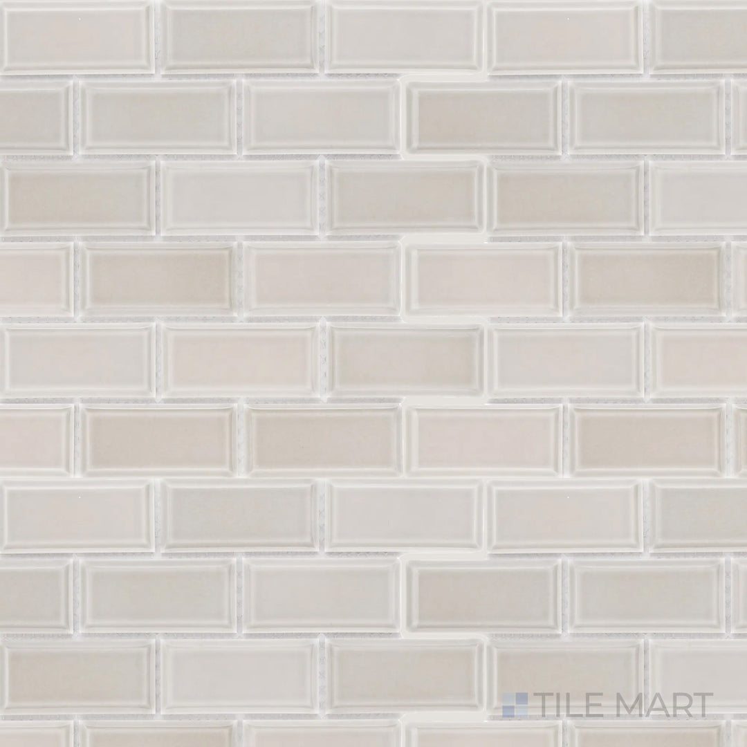 This overhead shot of the Cc Mosaics Plus Tender Gray 2x4 inch beveled bright glazed porcelain tile highlights its soft gray shade and polished surface, adding depth and sophistication.