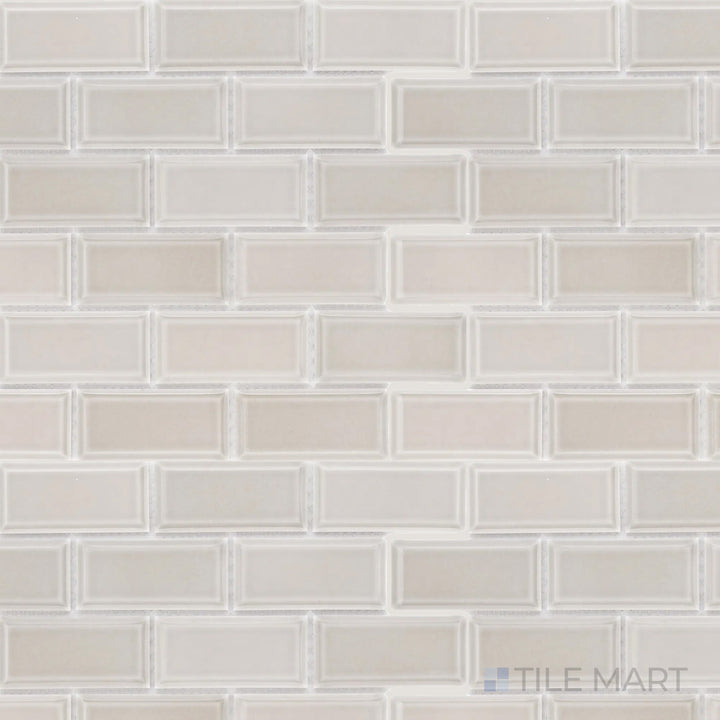 This overhead shot of the Cc Mosaics Plus Tender Gray 2x4 inch beveled bright glazed porcelain tile highlights its soft gray shade and polished surface, adding depth and sophistication.