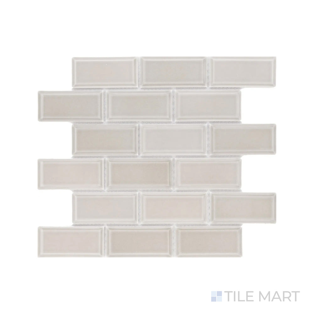 A high-resolution close-up of Cc Mosaics Plus Tender Gray 2X4 Beveled Bright Glazed Porcelain highlights its soft gray tone and beveled profile, enhancing light reflection.