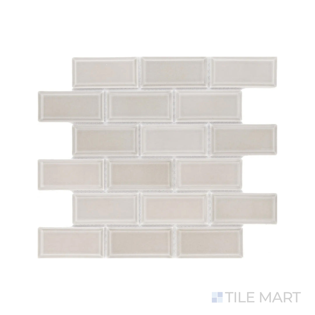 A high-resolution close-up of Cc Mosaics Plus Tender Gray 2X4 Beveled Bright Glazed Porcelain highlights its soft gray tone and beveled profile, enhancing light reflection.