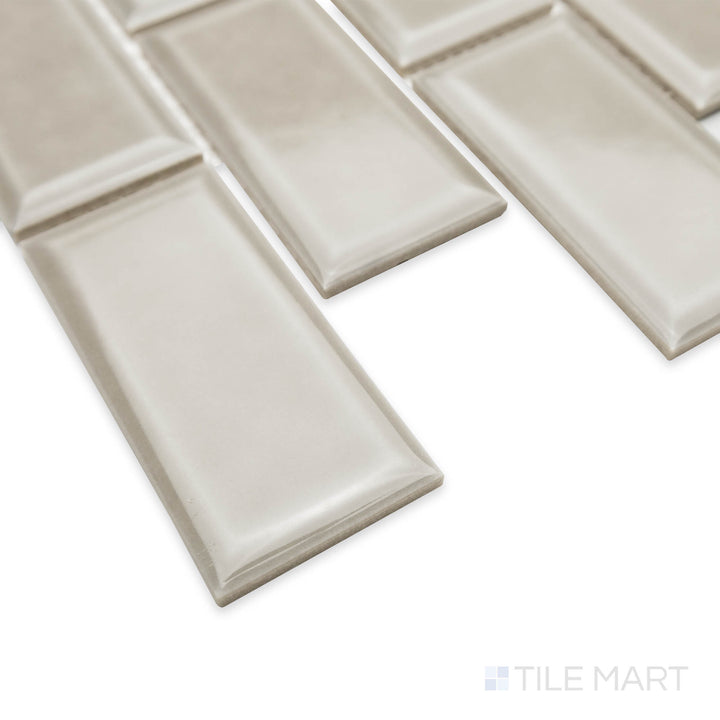 Corner shot of Cc Mosaics Plus Tender Gray 2X4 beveled bright glazed porcelain tile, showcasing its soft gray shade, beveled design, and clean transition at the tile junction.