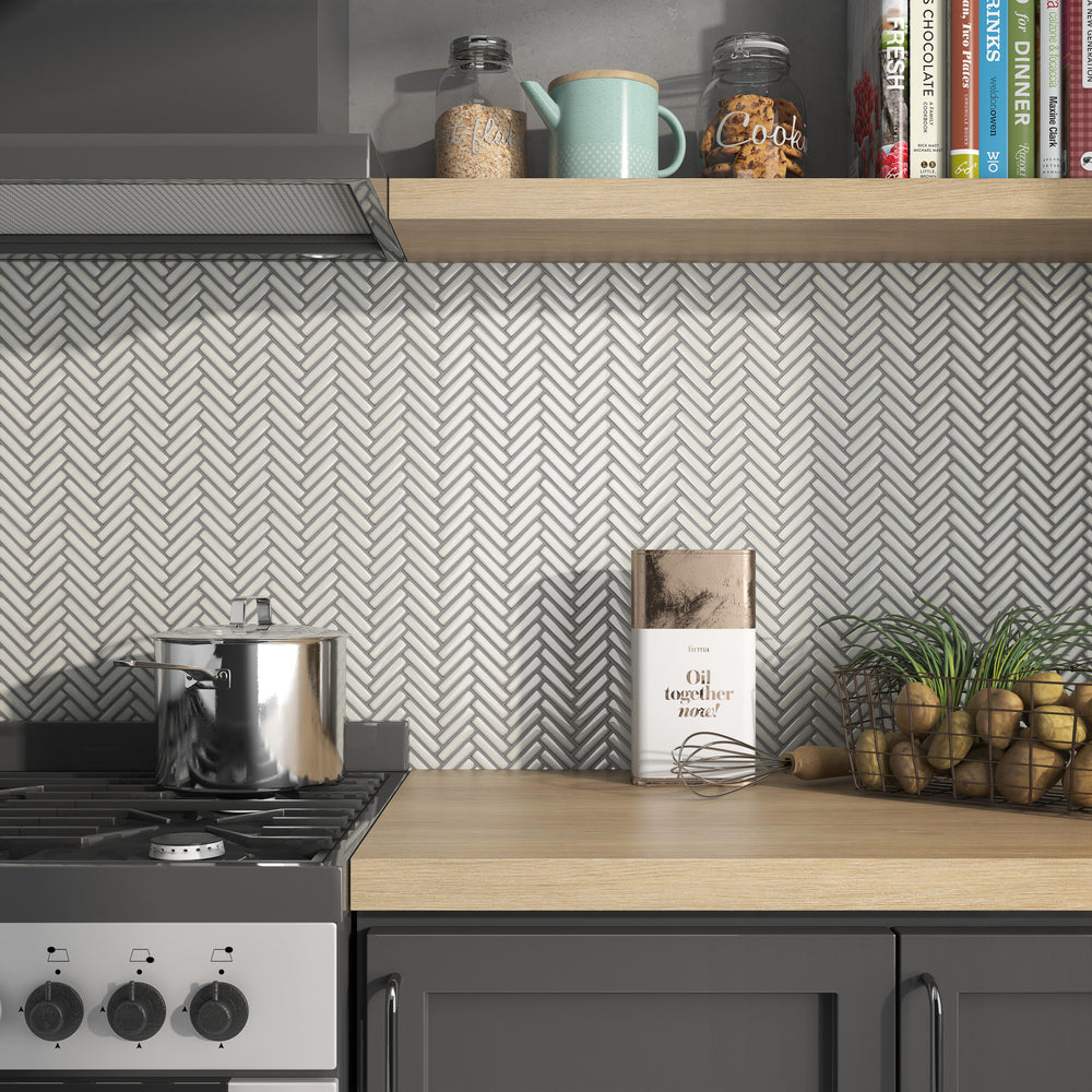 Cc Mosaics Plus Antique White Herringbone bright glazed porcelain tiles with a soft white hue and classic herringbone pattern for a refined look.