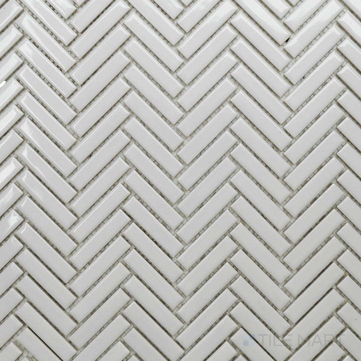 An overhead perspective of the Cc Mosaics Plus White Herringbone bright glazed porcelain tile reveals its clean white shade and dynamic herringbone layout, adding movement to any design.