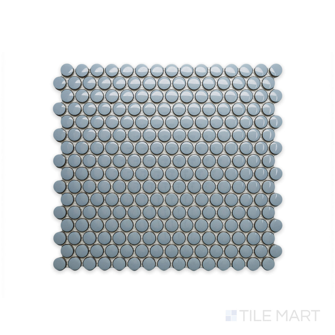 A close-up of Cc Mosaics Plus Sky Blue Penny Round Bright Glazed Porcelain showcases its playful penny tile design and refreshing blue glaze, bringing a lively aesthetic.