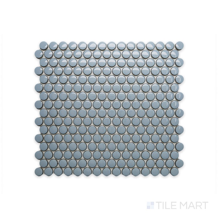 A close-up of Cc Mosaics Plus Sky Blue Penny Round Bright Glazed Porcelain showcases its playful penny tile design and refreshing blue glaze, bringing a lively aesthetic.