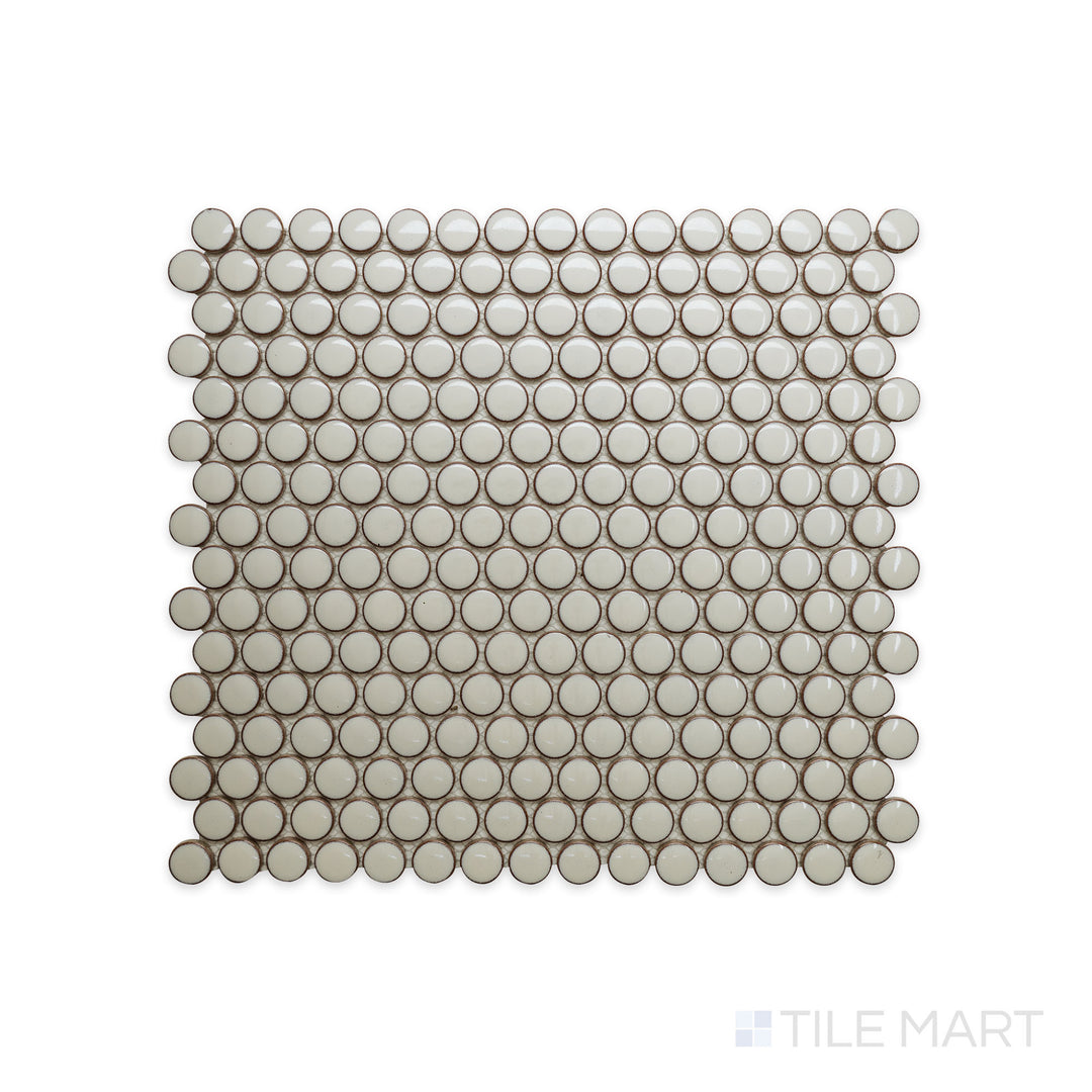 A detailed close-up of Cc Mosaics Plus Cream Penny Round Bright Glazed Porcelain highlights its warm neutral tone with a glossy round mosaic pattern, ideal for elegant accents.