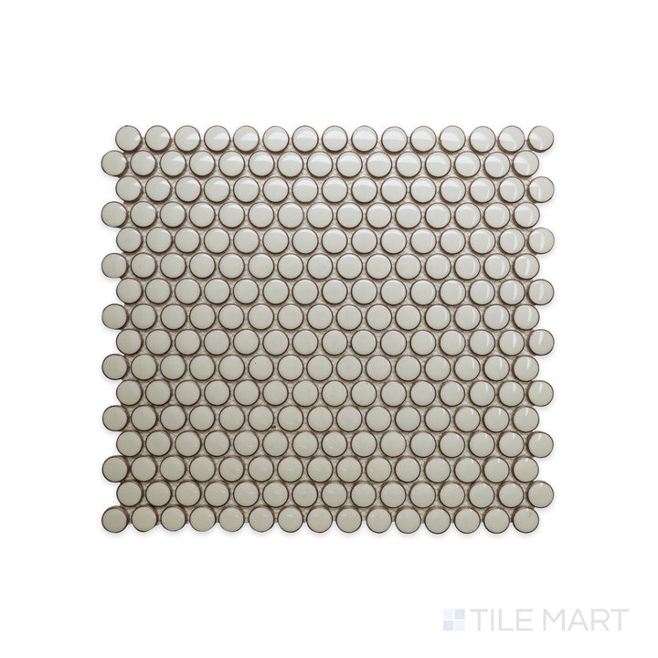 A detailed close-up of Cc Mosaics Plus Cream Penny Round Bright Glazed Porcelain highlights its warm neutral tone with a glossy round mosaic pattern, ideal for elegant accents.