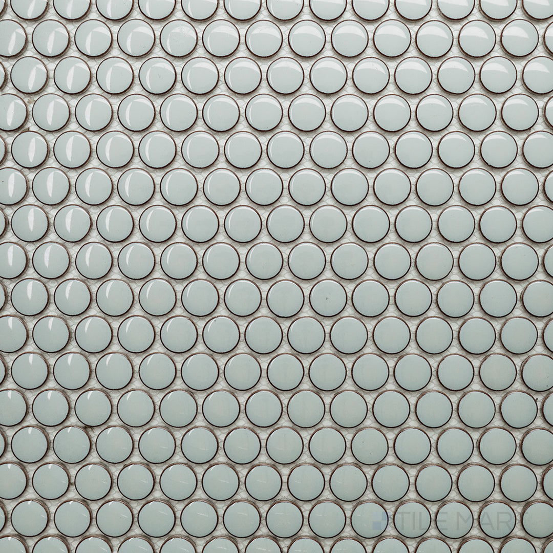 This top-down shot of the Cc Mosaics Plus Mint Green Penny Round bright glazed porcelain tile showcases its refreshing mint hue and circular tile arrangement for a vibrant and modern look.
