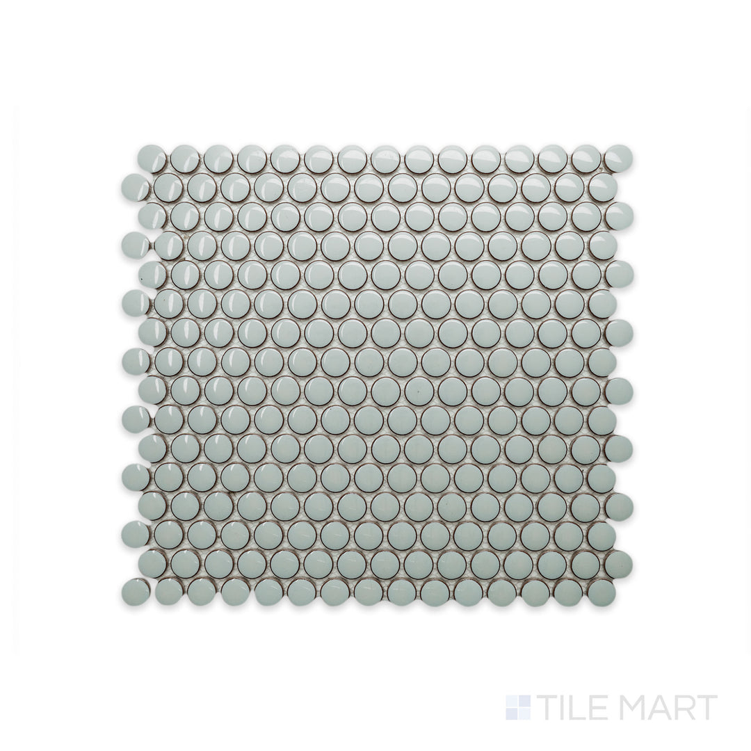 A macro shot of Cc Mosaics Plus Mint Green Penny Round Bright Glazed Porcelain reveals its soft green hue and polished penny-shaped tiles, adding a fresh and vibrant touch.