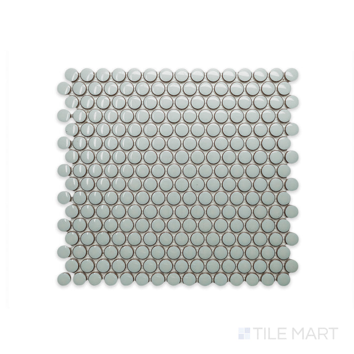 A macro shot of Cc Mosaics Plus Mint Green Penny Round Bright Glazed Porcelain reveals its soft green hue and polished penny-shaped tiles, adding a fresh and vibrant touch.