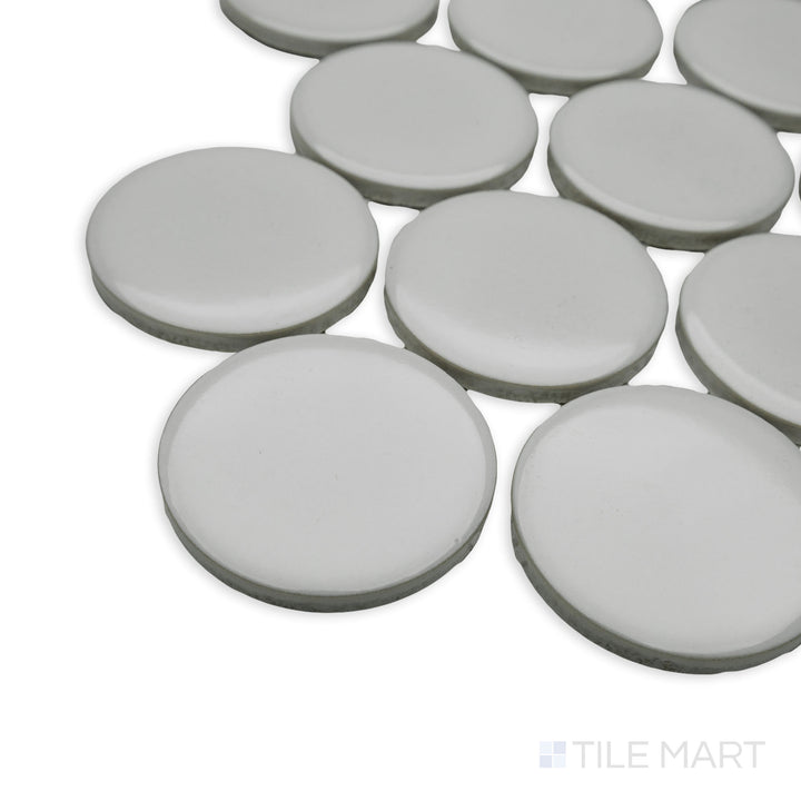 Corner-focused image of Cc Mosaics Plus White 2" dots bright glazed porcelain tile, emphasizing its small circular pattern, crisp white shade, and polished surface.