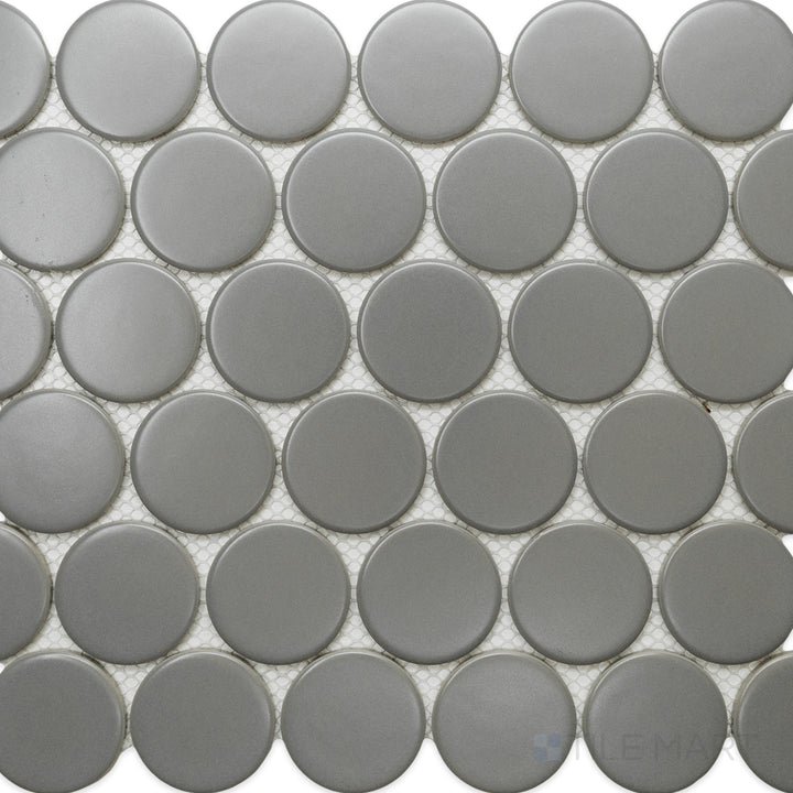 From a top-down perspective, the Cc Mosaics Plus Gray 2-inch Dots matte glazed porcelain tile features a modern gray tone with a non-glossy surface, creating a sleek and understated design.