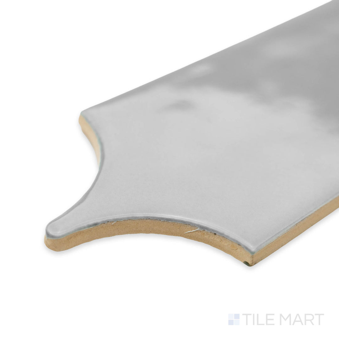 Side perspective of Feathers Neu Gray 3X12 bright ceramic tile, highlighting its neutral gray shade, reflective surface, and structured corner transition.