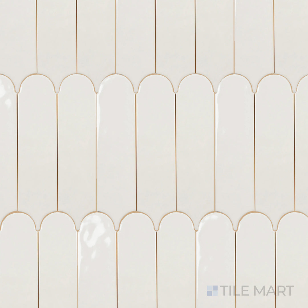 Captured from above, the Feathers Wool 3x12 inch bright ceramic tile features a warm neutral tone with a reflective surface, enhancing its soft yet contemporary appeal.